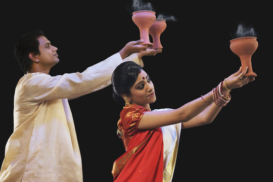 Bengali Couple Doing A Dhunuchi Dance 