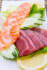 tuna and salmon sashimi on black dish