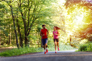 Young couple running in nature.
