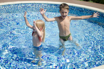 Sister and brother in the swimming pool. Happy children. Family vocation 