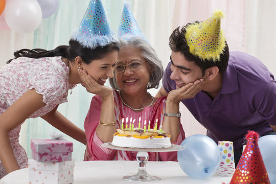 Woman celebrating birthday with grandchildren