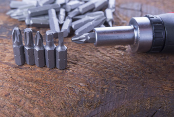 Metal screw driver heads, bits with screwdriver on the wood