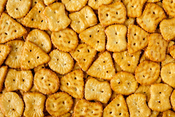 Top view of baked, salted tasty mini pretzels in different sTop view of baked, salted tasty mini pretzels or crackers in different shapes. Food texture backgroundhapes. Food texture background