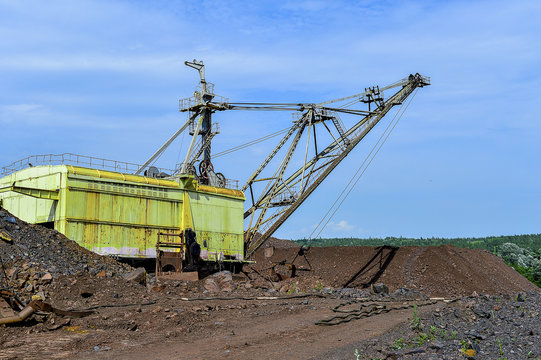 Excavator machine at excavation earthmoving work in quarry