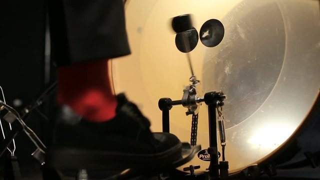 Drummer beats the rhythm into the bass drum with pedal