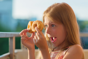 A child looks through a donut
