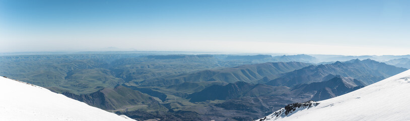 Fototapeta na wymiar Panorama View of the summer northern caucasus from the snow-capped summit of Elbrus