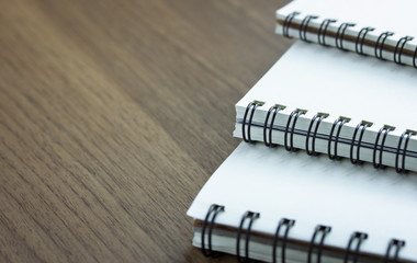 stack of spiral notebook on wood table