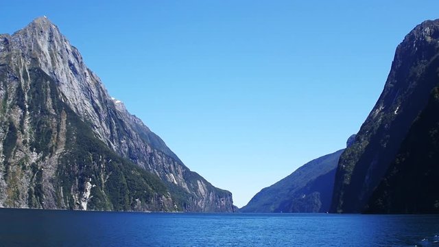 Wide slow motion pan, scenic lake and moutains in New Zealand