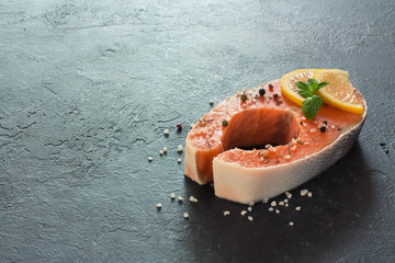 Raw salmon fillet with peppers and sea salt