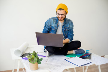 Hipster architect working with construction plans
