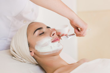 Spa facial mask application. Spa beauty organic facial mask application at day spa salon.