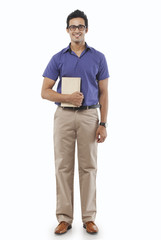 Fototapeta premium Portrait of a young man with a book smiling