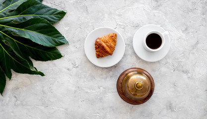 Ask for the bill at restaurant. Service bell near cup of coffee on grey stone table top view copyspace