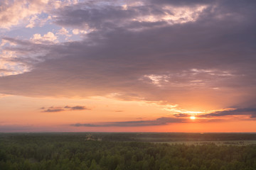 Colourful sky and forest silhouette at sunset.