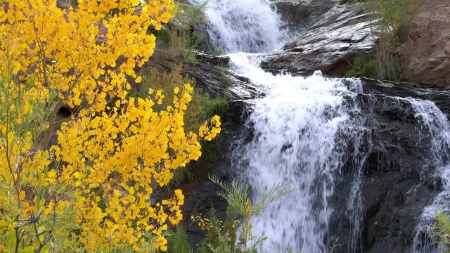 Small waterfall flowing through desert landscape during Autumn at Faux Falls Moab, UT.