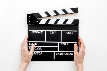 Filmmaker profession. Clapperboard on white background top view
