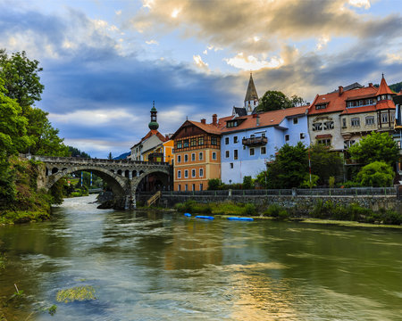 Beautiful sunset view of city of Murau with river, houses and church in Tirol, Austria, Europe.