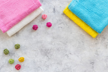 Linen after washing. Clean towel on grey stone background top view copyspace