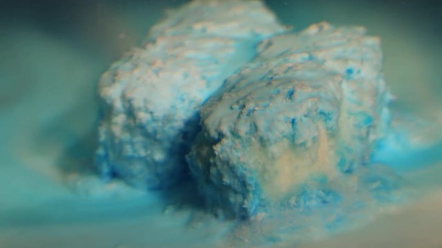 Timelapse, blue pills dissolve in water
