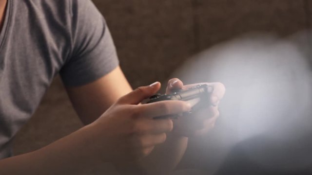 Close up of happy man playing on a controller
