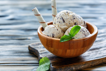 Homemade ice cream with chocolate crumb in bowl.