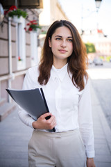 Fototapeta premium Focused business girl with a folder in her hand