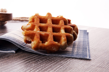 Traditional belgian waffles on brown wooden board