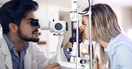 optometrist checking patient eyesight and vision correction - Powered by Adobe