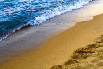 Wave of the ocean with sand beach.