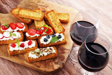 Bread Brushetta or authentic traditional spanish tapas set for lunch table. Sharing antipasti on party or summer picnic time over wooden rustic background.
