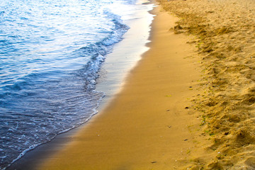 Wave of the ocean with sand beach.