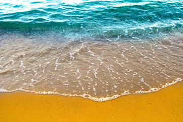 Wave of the ocean with sand beach.