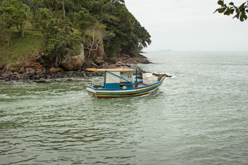Naklejka na ściany i meble small fish boat sets out to open sea