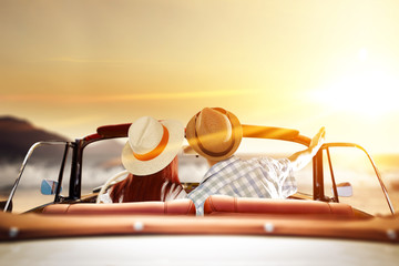 two lovers in retro car and golden sunset time 