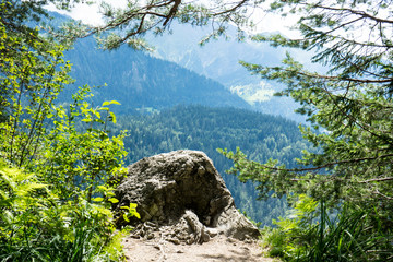 Fototapeta na wymiar big stone on mountain cliff with stunning panorama view