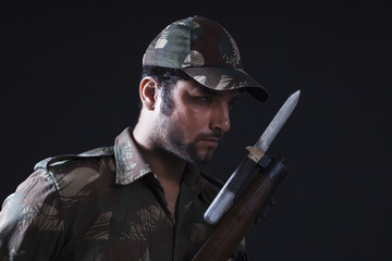 Close-up of soldier with gun 