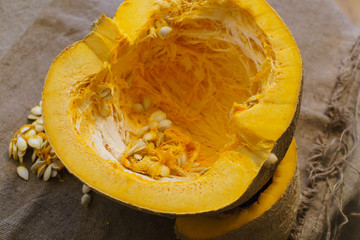Pieces of cut pumpkin together with pumpkin seeds.