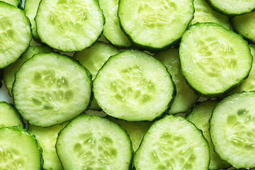 Fresh cucumber slices as background