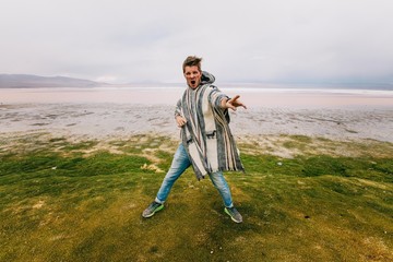 Boy having fun in Uyuni salt flats view