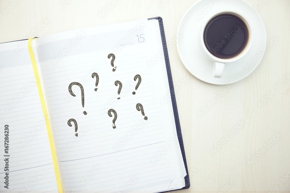 Poster question marks on notepad