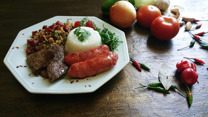 lunch with barbecue and various vegetables on the table