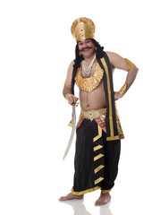 Portrait of a man dressed as Raavan with a sword 