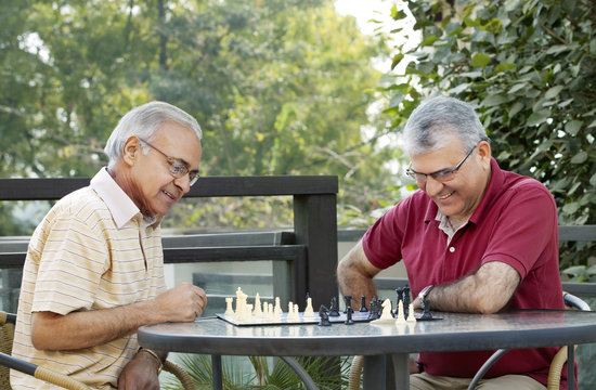 Senior men playing chess in leisure time 