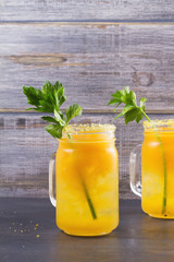 Bloody mary cocktail made with yellow tomatoes. Tomato juice with celery, spices, salt and ice