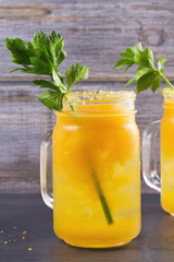 Bloody mary cocktail made with yellow tomatoes. Tomato juice with celery, spices, salt and ice