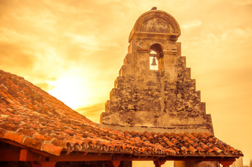 View on Sunset over church stone tower by forttress of cartagena - obrazy, fototapety, plakaty