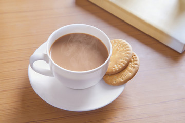 Close-up of biscuits and hot tea on table