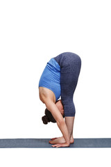 Woman doing yoga asana Uttanasana - standing forward bend