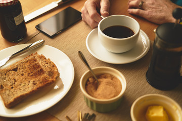 A man enjoying a hot drink of coffee in the morning before starting work.